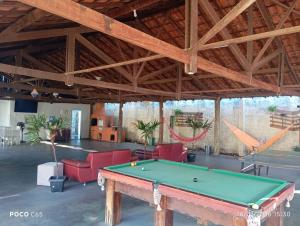 a large room with a pool table in it at Suits Recanto do Sabiá in Brotas