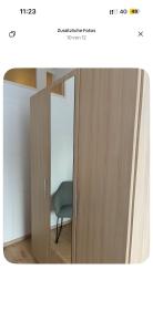 a room with a mirror and a door with a chair at Comfortable Private Room in a Prime Location! HBF in Wolfsburg