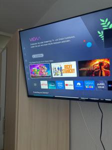 a flat screen tv hanging on a wall at Comfortable Private Room in a Prime Location! HBF in Wolfsburg