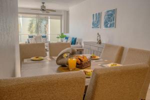 a dining room with a table with food and drinks on it at NITTA 209 Elegant Apartment - Partial Sea Views in Nuevo Nayarit