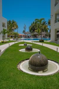 a park with two large spheres in the grass at NITTA 209 Elegant Apartment - Partial Sea Views in Nuevo Nayarit