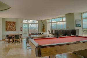 a pool table in a room with tables and chairs at NITTA 209 Elegant Apartment - Partial Sea Views in Nuevo Nayarit