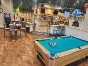 a pool table in a restaurant with a bar at Chieftain Conference Center in Carrington