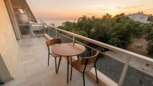 a balcony with two chairs and a table at Kineta Prime Suites No5 in Kineta