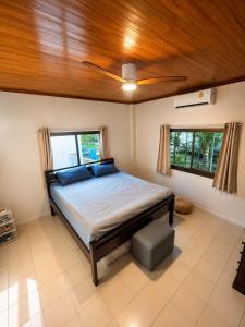 a bedroom with a bed with a ceiling fan at SU house Koh Phangan in Thong Nai Pan Yai +42 photos
