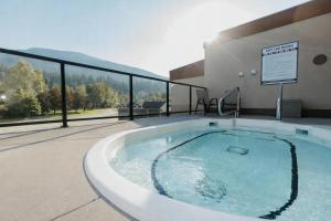 a hot tub in the middle of a building at Northwinds Hotel Revelstoke in Revelstoke