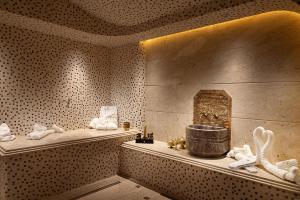 a room with some white towels and a tub at Hotel Supreme in El Biar