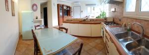 a kitchen with a sink and a table in it at Casa Mille Lire in Ciampino