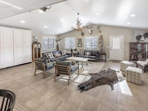a living room with a couch and chairs and a table at MTN Meadow Retreat near PC in Peoa