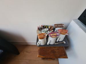 a tray with mugs and utensils on a table at The West Pier Residence in Brighton & Hove