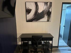 a black desk in a room with a painting on the wall at Keyes Motel in Arlington Heights
