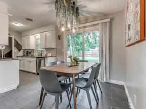 a kitchen with a dining room table and chairs at Norman Home with Game Room in Norman