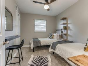 a room with two beds and a chair in it at Norman Home with Game Room in Norman