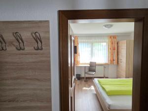 a bedroom with a bed and a desk with a chair at Siegele - Top 1 in Kappl