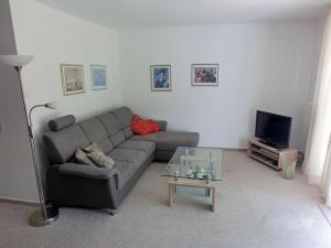 a living room with a couch and a tv at Fährhof 6b EG in Wiek auf Rügen
