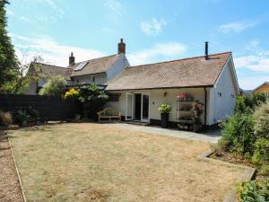 an exterior view of a house with a yard at The Annexe Shotley Cottage in Ipswich