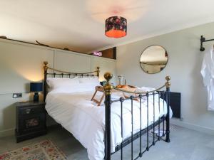 a bedroom with a bed and a mirror at The Annexe Shotley Cottage in Ipswich