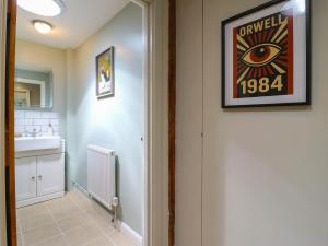 a bathroom with a sink and a picture on the wall at The Annexe Shotley Cottage in Ipswich +16 photos