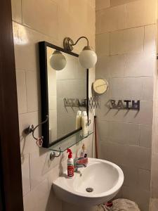 a bathroom with a white sink and a mirror at Cozy chalet in El Alamein +9 photos