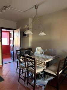 a dining room with a table and chairs at Cozy chalet in El Alamein