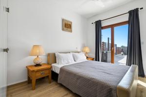 a bedroom with a large bed and a window at Modern Villa HG08 Pyrinas with Amazing Golf Views, in heart of Aphrodite Hills in Kouklia +27 photos