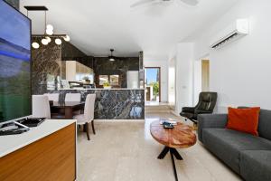 a living room with a couch and a table at Modern Villa HG08 Pyrinas with Amazing Golf Views, in heart of Aphrodite Hills in Kouklia
