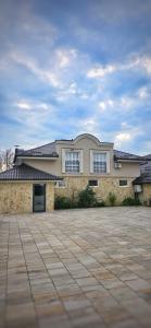 a large house with a driveway in front of it at Jezero Rudanka in Doboj