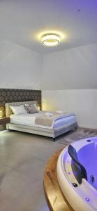 a bedroom with a bed and a bath tub at Jezero Rudanka in Doboj +35 photos