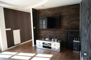 a living room with a television on a wall at Jezero Rudanka in Doboj