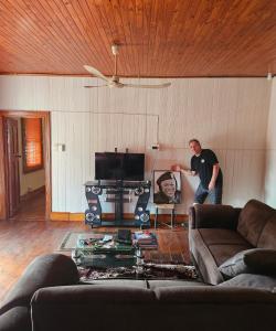 a man standing in a living room with a tv at JJK free Breakfast in Barberton
