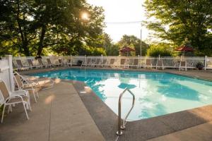 a large swimming pool with chairs and tables and chairs at Ogunquit The Milestone Inn in Ogunquit
