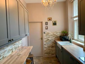a kitchen with a counter and a sink and a chandelier at Downton I in Alnwick
