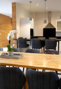 a dining room with a wooden table and chairs at Gîte De La Crayère in Gionges +17 photos