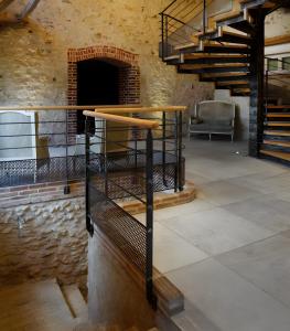 a room with a table and stairs in a building at Gîte De La Crayère in Gionges
