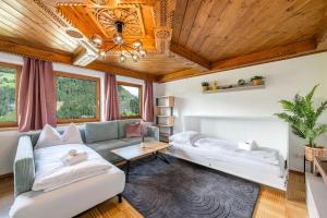 a living room with a couch and a table at Chalet BergMoment - by myNests in Rohrmoos
