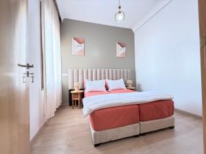 a bedroom with a bed with red and white sheets at Riad Marrakech, oasis apartment in Marrakesh
