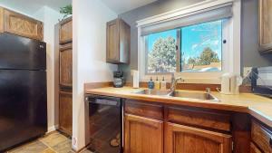 a kitchen with a sink and a window at Mountain Condo | Spa Pool and Ski Shuttle Access in Mammoth Lakes