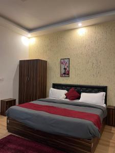 a bedroom with a large bed in a room at Moonshiva stay and cafe in Rishīkesh