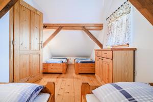 a bedroom with two beds and a cabinet and a window at Holiday Home Marta with 4 Bedrooms in Raka