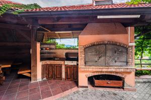 an outdoor kitchen with an outdoor oven in a patio at Holiday Home Marta with 4 Bedrooms in Raka +46 photos