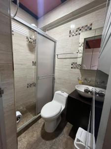 a bathroom with a toilet and a sink at Casa Hotel Villa María - Apia in Apía