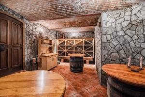 a room with a wooden table and a wine cellar at Holiday Home Marta with 4 Bedrooms in Raka