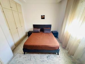 a bedroom with a bed in a room at Eden Cozy Airport in El Aouina Station
