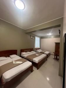 a group of four beds in a room at Gran Marañon Hotel in Iquitos