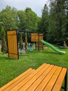 a park with a playground with a bench and a slide at Gościnne Pieniny Pensjonat in Jaworki