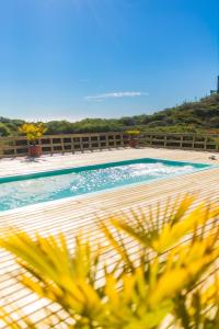 a swimming pool with a view of the ocean at Cabañas Isla del Mar in Constitución