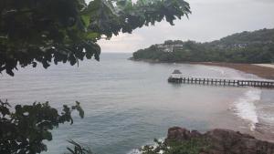 a dock in the water next to a beach at EnDanni homestay in Phuket