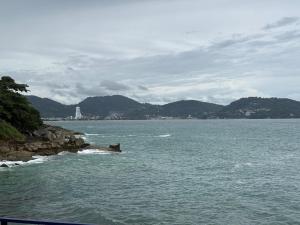 a large body of water with mountains in the background at EnDanni homestay in Phuket