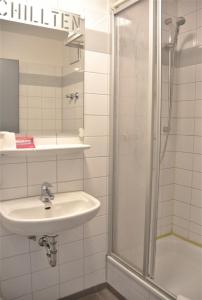 a bathroom with a sink and a shower at Chillten Bottrop in Bottrop +20 photos