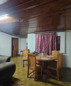 a dining room with a table and chairs and a couch at JJK free Breakfast in Barberton